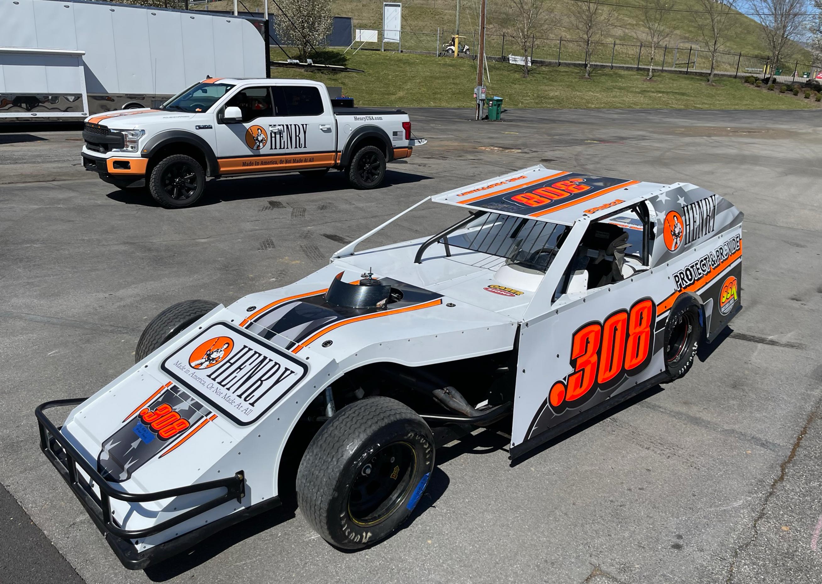 A Henry racecar parked behind the pit